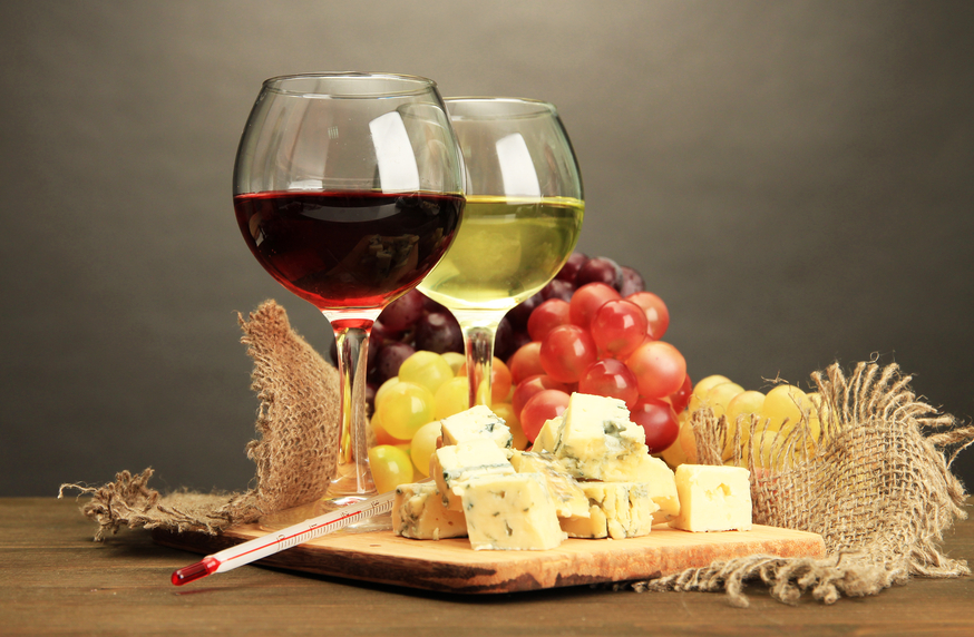 Composition with wine, blue cheese and grape on wooden table, on grey background