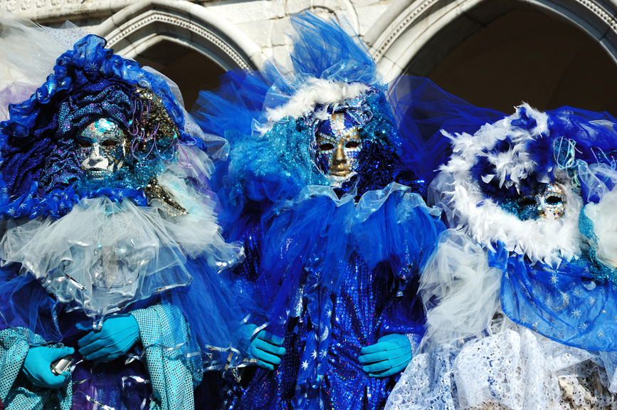 VENICE – MARCH 8: Three masks dressed in blue costumes at St. Ma