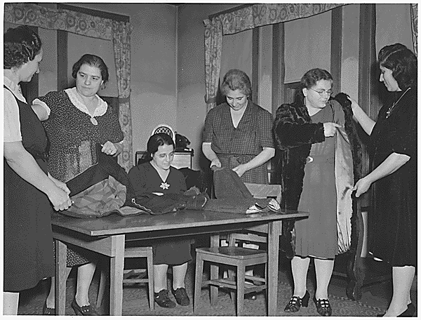 Italian American Women making old garments as good as new - saving material during WW11